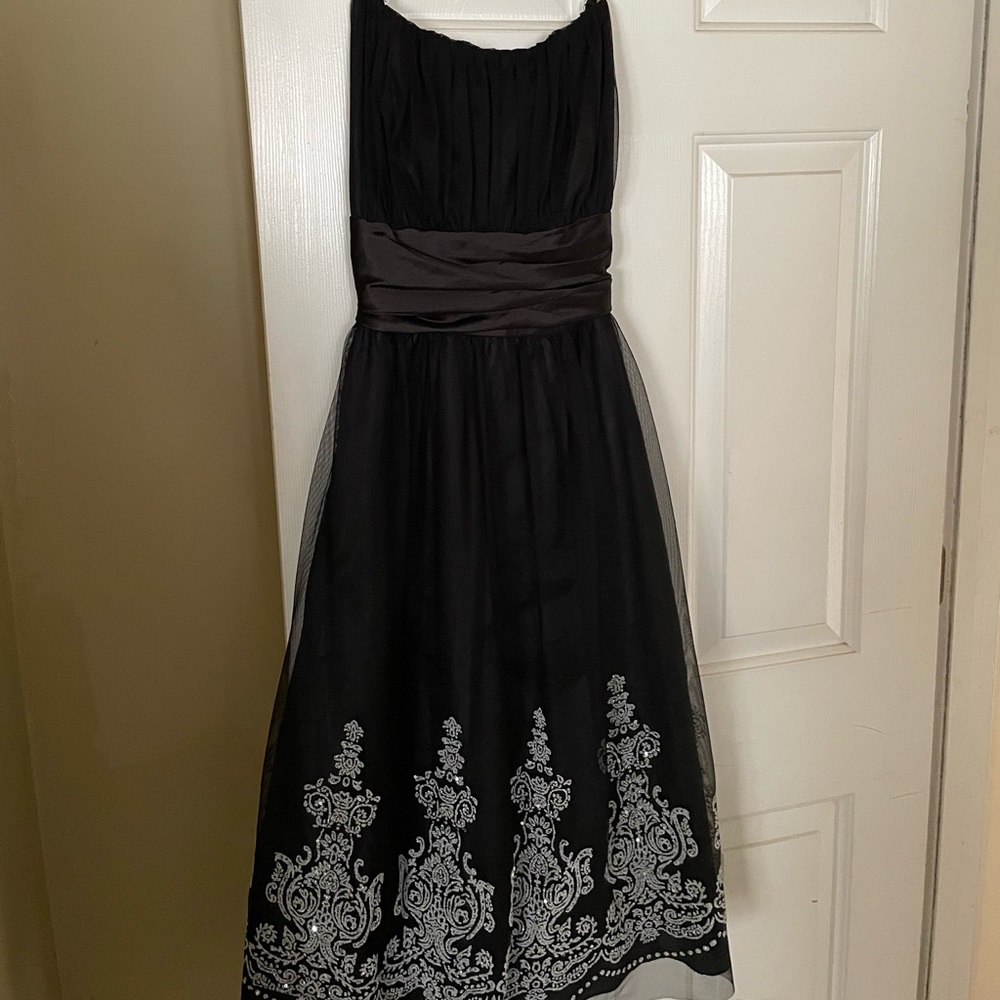 Black cocktail dress with adjustable spaghetti straps.